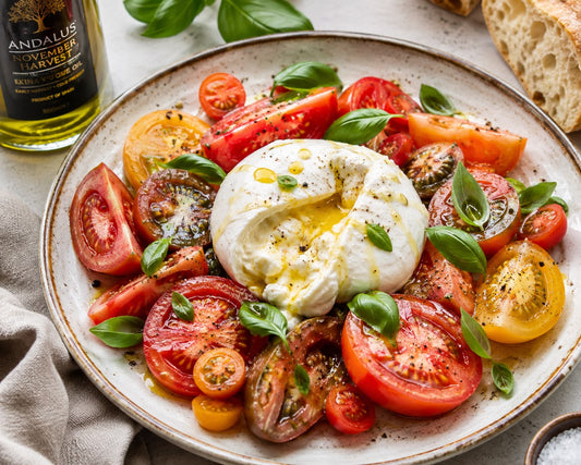 Mediterranean tomato and burrata salad with extra virgin olive oil, fresh basil and ripe tomatoes.